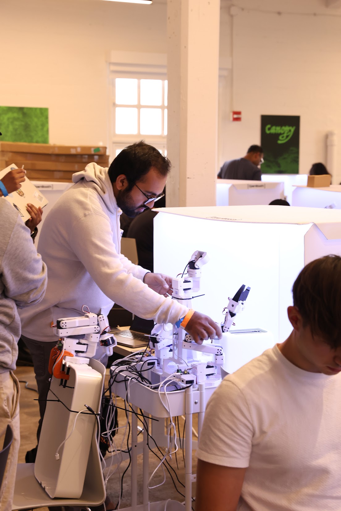 Harsh Dhruva working with robot arms