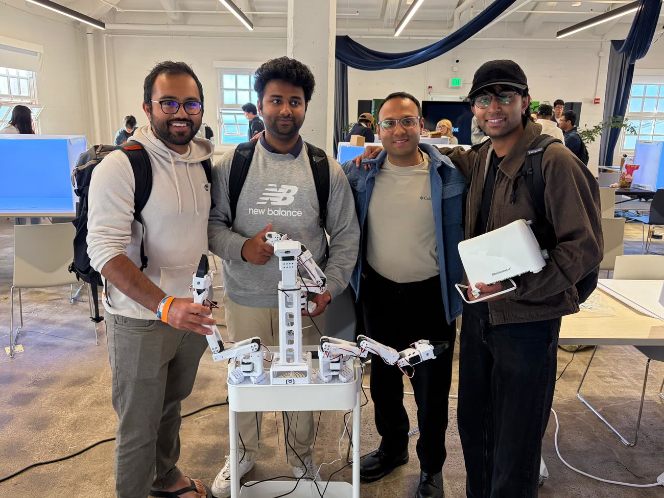 The four-person hackathon team with their robot