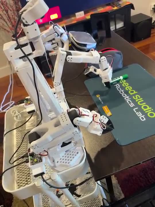 A robot arm picking up a pen from a table